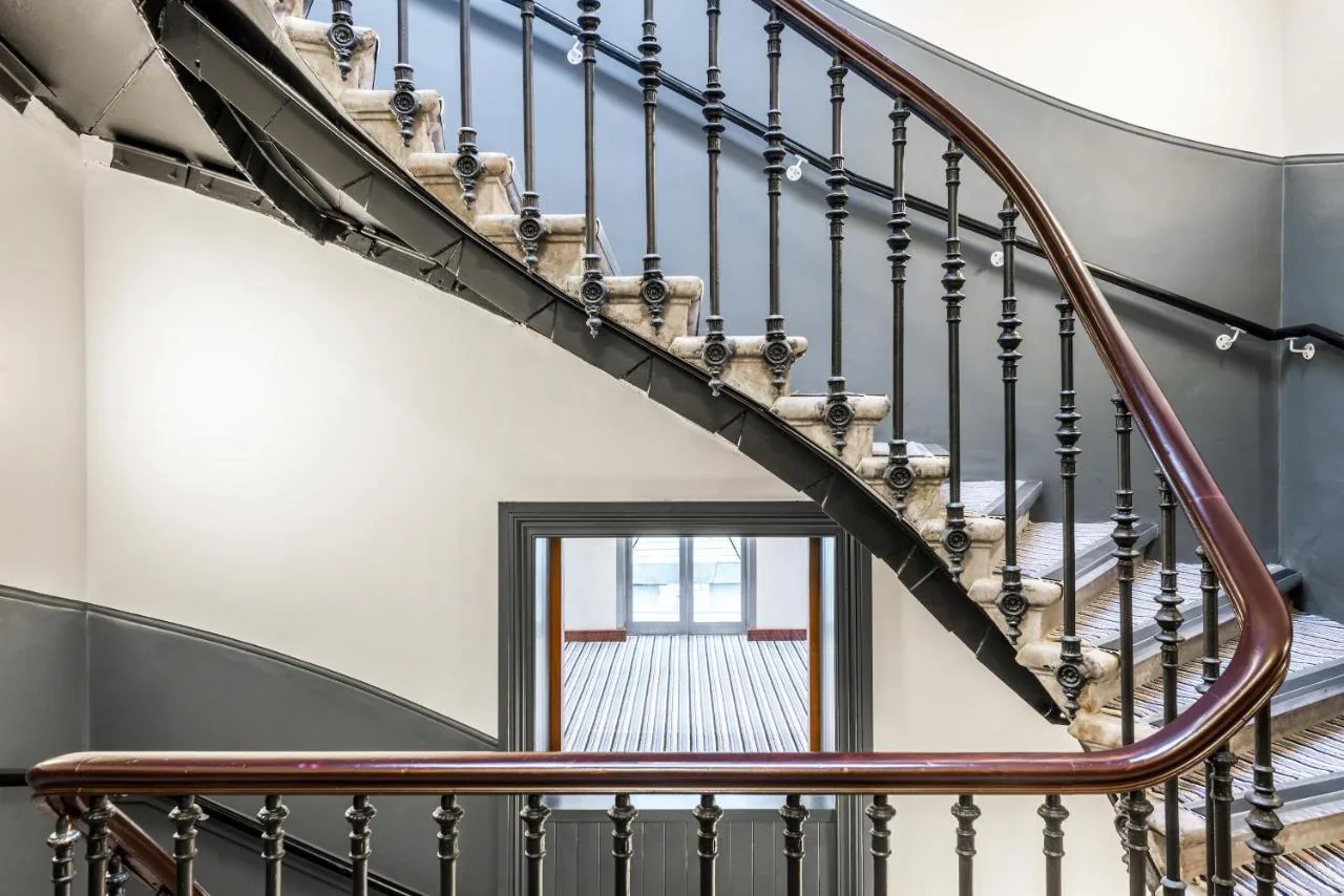 a spiral staircase in a house with a window at The Z Hotel Glasgow in Glasgow
